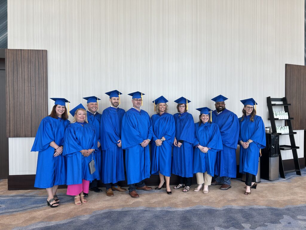 group of 10 ACHE leaders in cap and gown for Regent installment